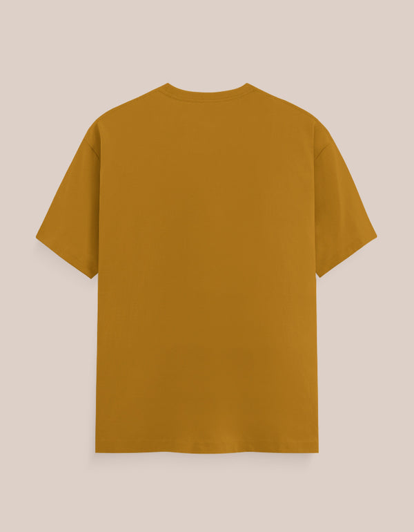 Back view of a mustard yellow t-shirt on a beige background