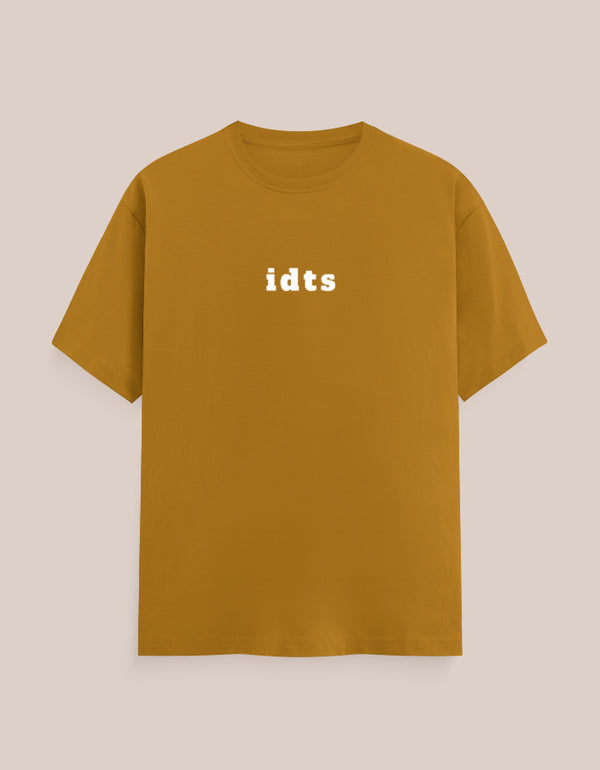 Mustard yellow t-shirt with 'idts' text on a beige background