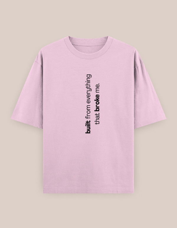 Pink t-shirt with black text on a beige background