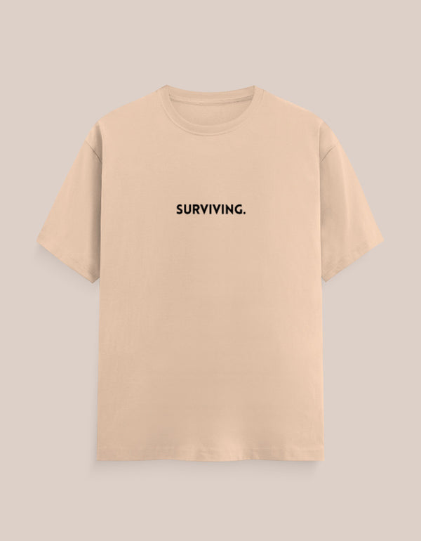 Beige t-shirt with 'SURVIVING.' text on a beige background