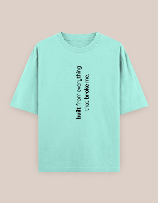 Mint green t-shirt with black text on a beige background